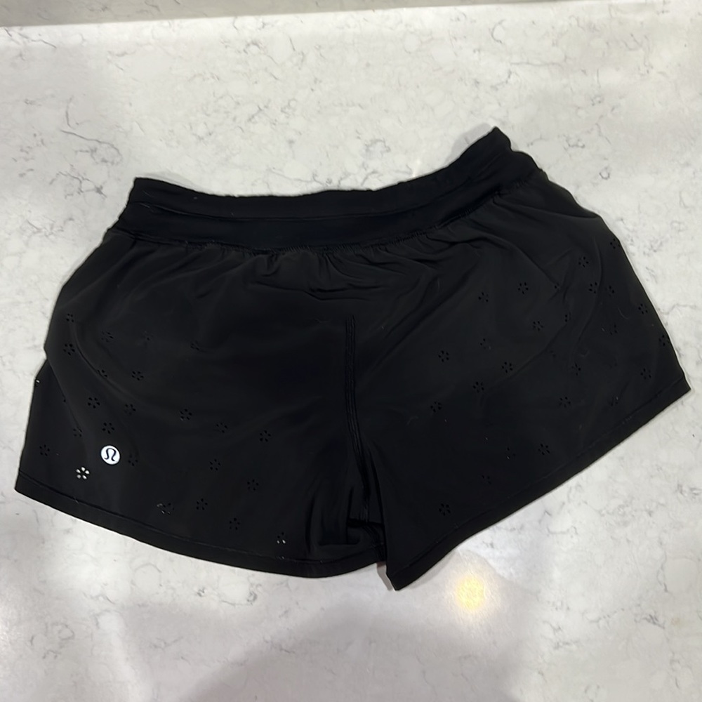Black Lululemon running shorts with cut out detail